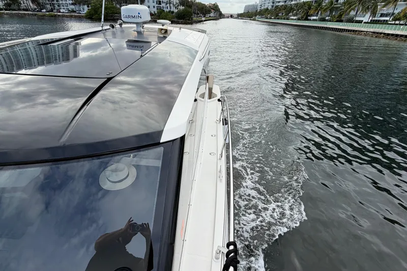 Slide: The Image of 2019 Carver C34 yacht cruising through a scenic waterway. - 7