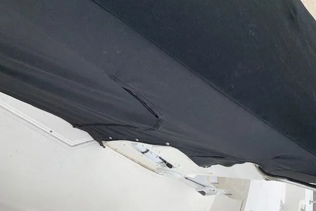 Slide: The Image of 2023 Boston Whaler 170 Montauk boat covered with a black protective tarp. - 12