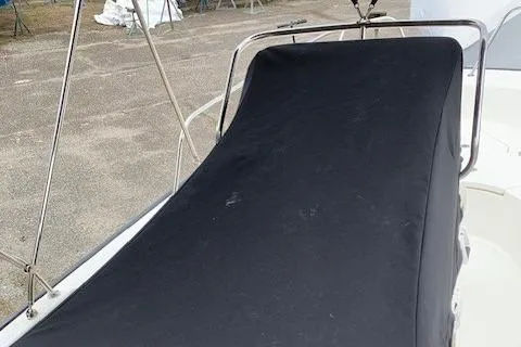 Slide: The Image of 2023 Boston Whaler 170 Montauk boat with black cover on deck. - 13