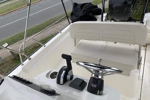 Slide: The Image of 2023 Boston Whaler 170 Montauk boat interior with steering wheel and controls. - 18