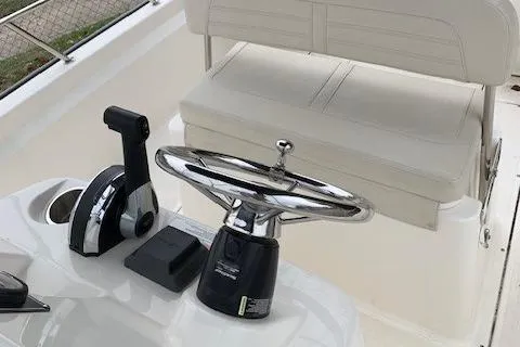 Slide: The Image of 2023 Boston Whaler 170 Montauk boat helm with steering wheel and controls. - 20