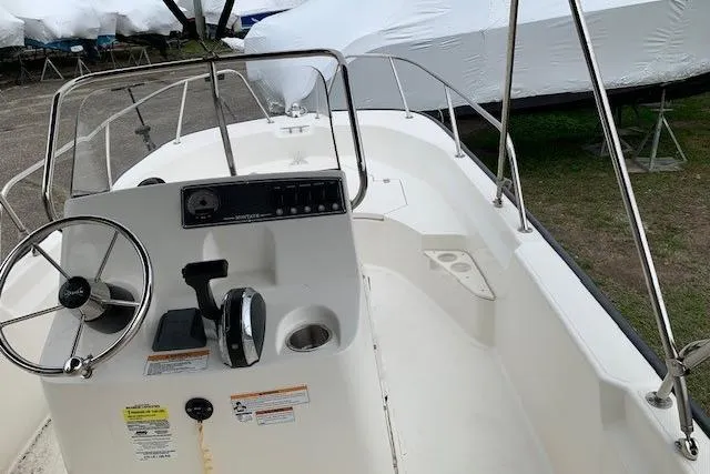 Slide: The Image of 2023 Boston Whaler 170 Montauk boat interior with steering wheel and control panel. - 23