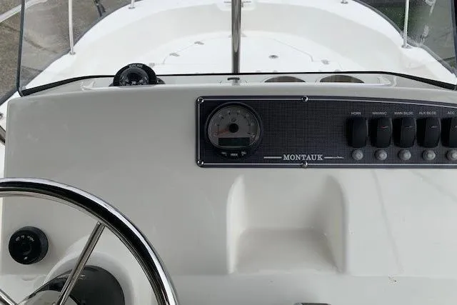 Slide: The Image of 2023 Boston Whaler 170 Montauk dashboard with steering wheel and control panel. - 24