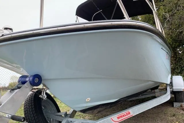 Slide: The Image of 2023 Boston Whaler 170 Montauk boat on trailer, side view with canopy. - 9
