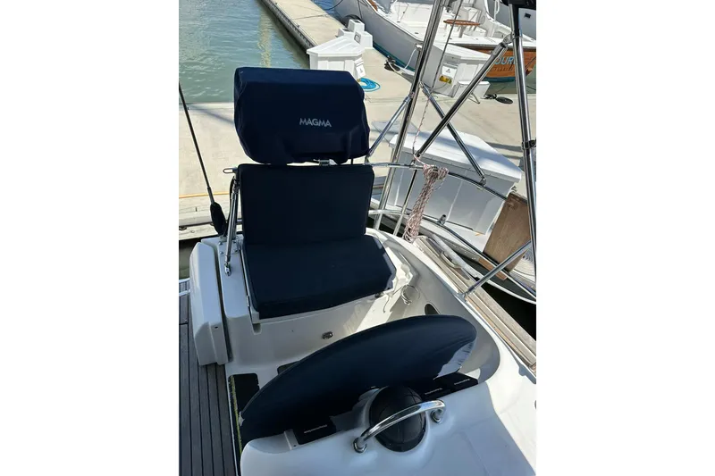 Slide: The Image of Cockpit seating on a 2000 Beneteau 50 sailboat, featuring navy cushions and stainless steel railings. - 10