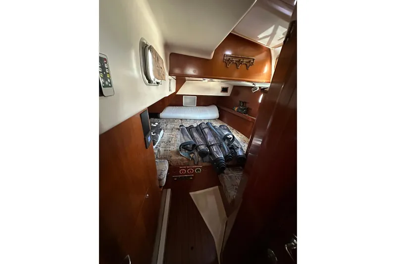 Slide: The Image of Interior cabin of a 2000 Beneteau 50 yacht with wooden finishes and equipment. - 100