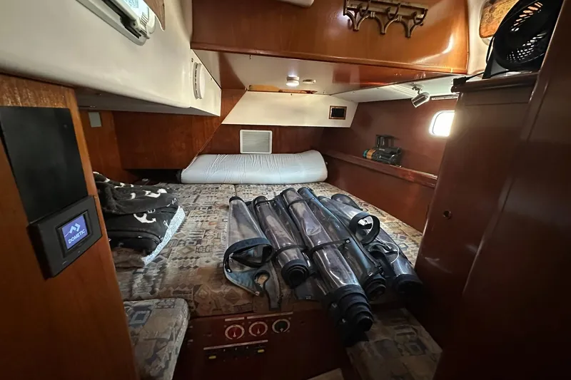 Slide: The Image of Cozy cabin interior of a 2000 Beneteau 50 yacht with rolled sails. - 101