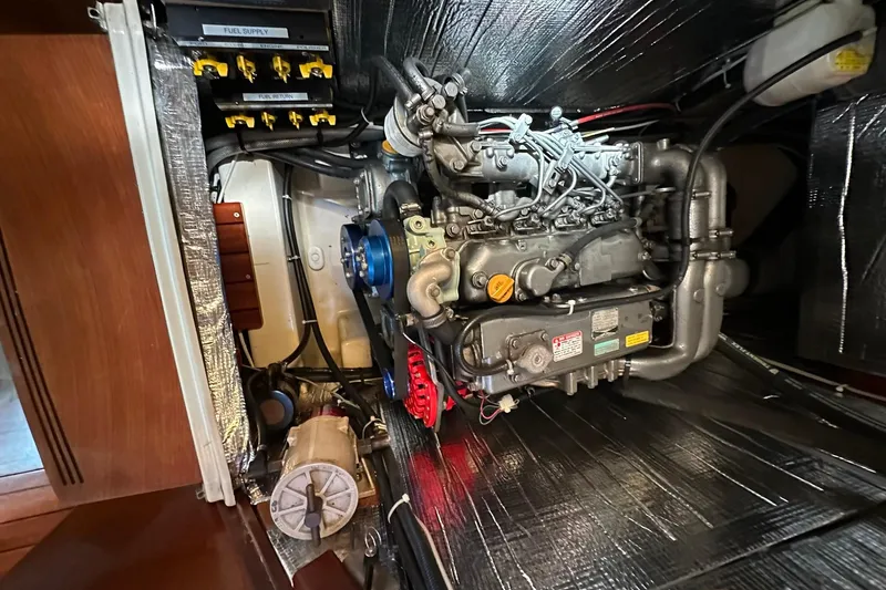 Slide: The Image of Engine compartment of a 2000 Beneteau 50 sailboat, showcasing mechanical components. - 107