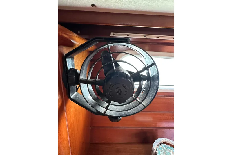 Slide: The Image of Wall-mounted fan inside a 2000 Beneteau 50 yacht, featuring wooden interior paneling. - 115