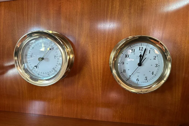 Slide: The Image of Brass barometer and clock on Beneteau 50 yacht, 2000 model, wooden panel background. - 117
