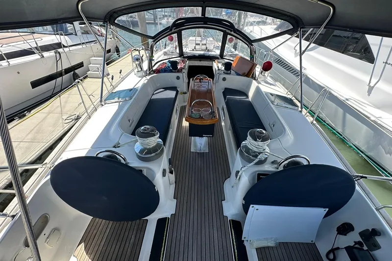 Slide: The Image of Cockpit of a 2000 Beneteau 50 sailboat, featuring seating and steering wheel. - 12