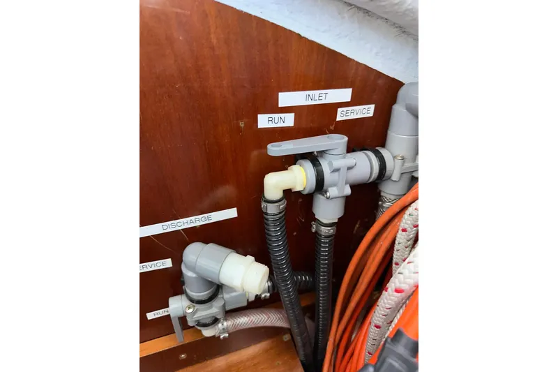 Slide: The Image of Plumbing system on a 2000 Beneteau 50 yacht, showing labeled pipes and valves. - 122