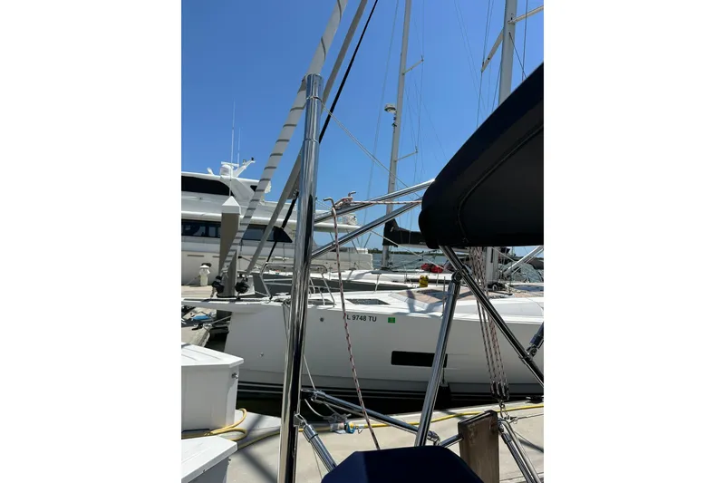 Slide: The Image of Sailboats docked at marina, featuring a 2000 Beneteau 50 under clear blue sky. - 126