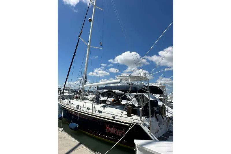 Slide: The Image of Sailing yacht Beneteau 50, 2000 model, docked under a clear blue sky. - 2