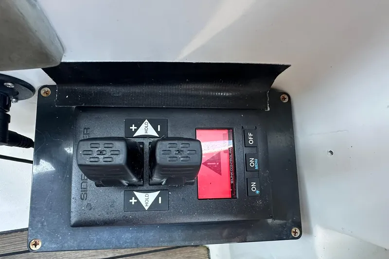 Slide: The Image of Control panel of a 2000 Beneteau 50 yacht with switches and buttons. - 23