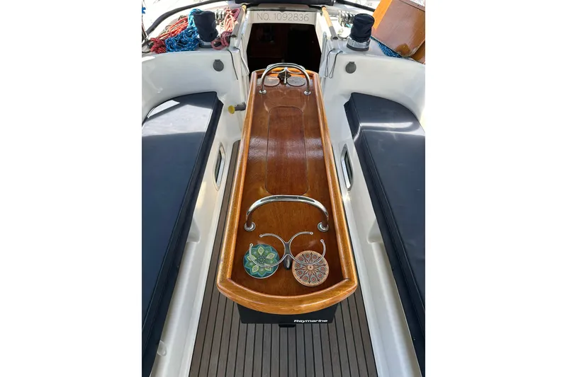 Slide: The Image of Cockpit of a 2000 Beneteau 50 sailboat with wooden table and nautical decor. - 26