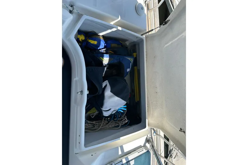 Slide: The Image of Storage compartment on a 2000 Beneteau 50 yacht, containing life jackets and ropes. - 27