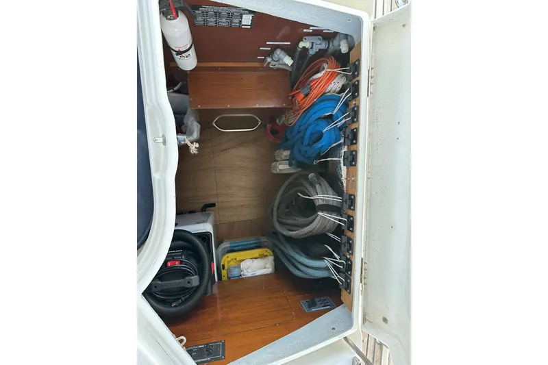 Slide: The Image of Storage compartment of a 2000 Beneteau 50 yacht with organized ropes and equipment. - 28