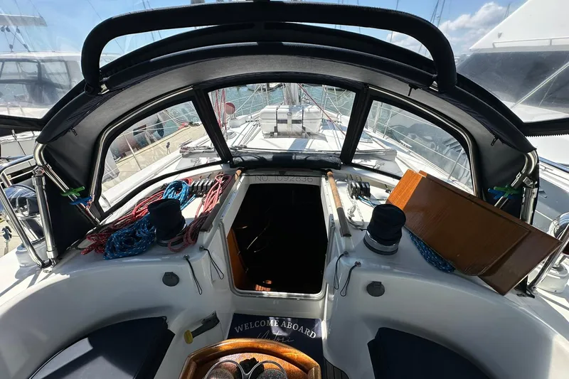 Slide: The Image of Cockpit view of a 2000 Beneteau 50 sailboat with ropes and equipment. - 34