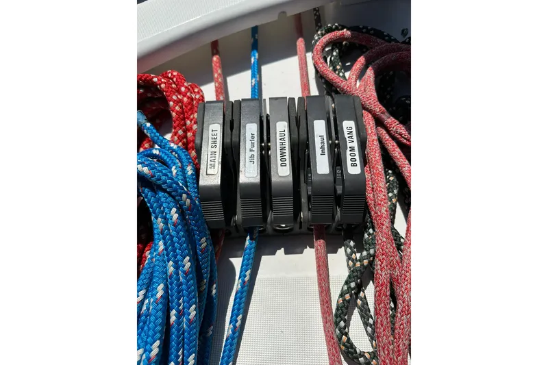 Slide: The Image of Close-up of labeled rope clutches on a 2000 Beneteau 50 sailboat. - 37