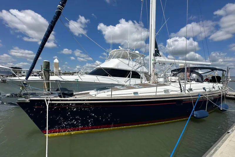 Slide: The Image of Sailing yacht Beneteau 50, 2000 model, docked at marina under blue sky. - 4