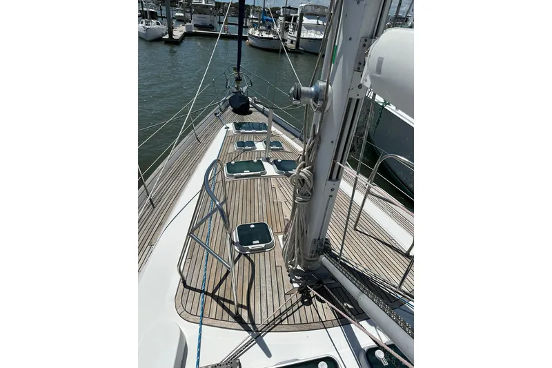 Slide: The Image of Deck view of a 2000 Beneteau 50 sailboat in a marina. - 43