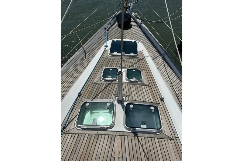 Slide: The Image of Deck view of 2000 Beneteau 50 sailboat with multiple hatches and teak finish. - 45