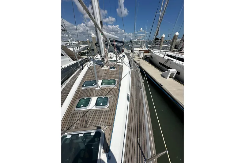 Slide: The Image of Sailboat deck view of 2000 Beneteau 50, docked at marina under blue sky. - 46