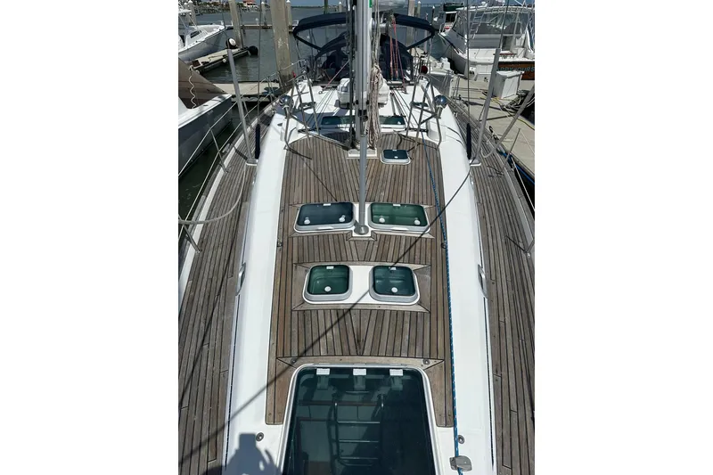 Slide: The Image of Deck view of a 2000 Beneteau 50 sailboat with wooden finish and hatches. - 48