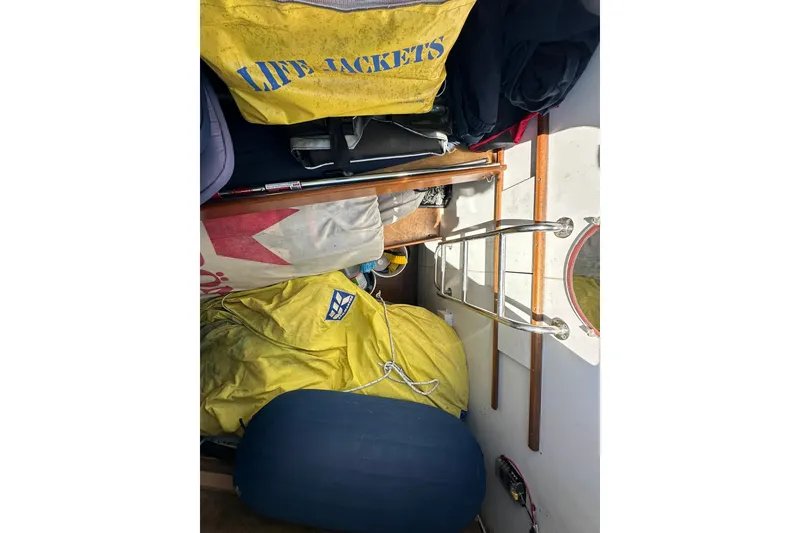 Slide: The Image of Interior of a 2000 Beneteau 50 sailboat with life jackets and nautical gear. - 49