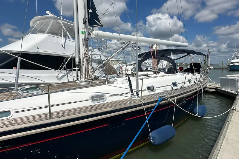 Slide: The Image of Sailing yacht Beneteau 50, 2000 model, docked at marina under blue sky. - 5