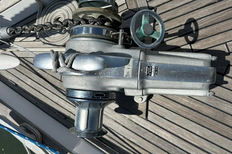 Slide: The Image of Anchor windlass on 2000 Beneteau 50 yacht deck, featuring metal components and chain. - 50