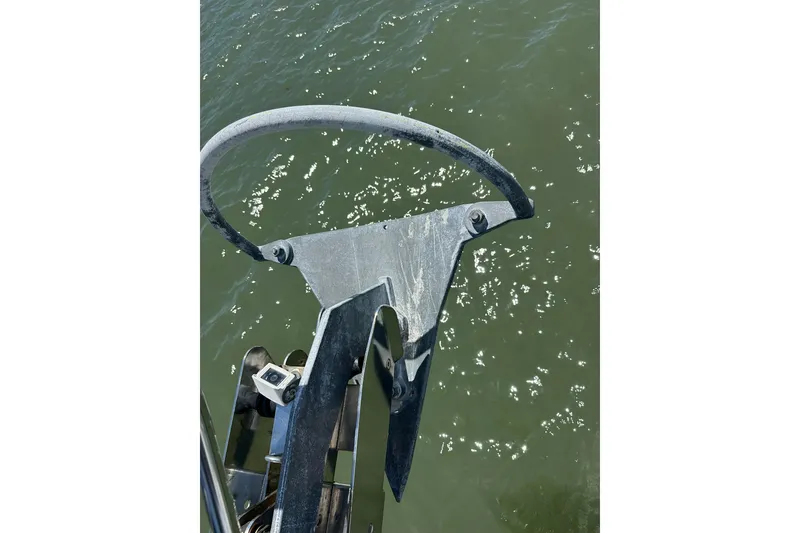 Slide: The Image of Anchor of a 2000 Beneteau 50 yacht over water. - 52