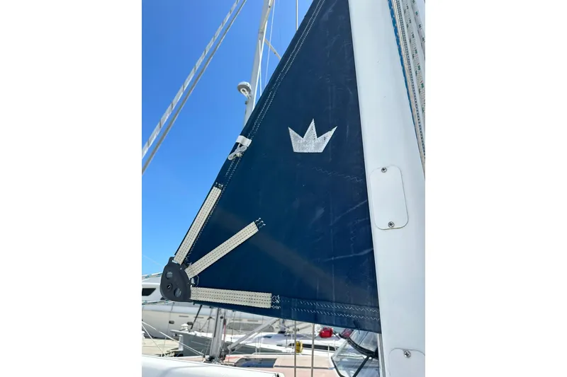 Slide: The Image of Close-up of a 2000 Beneteau 50 sailboat's sail with a crown emblem. - 55