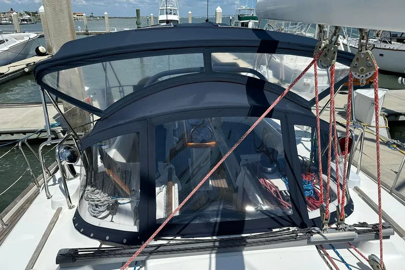 Slide: The Image of Beneteau 50 sailboat from 2000 docked, featuring a blue canopy and visible rigging. - 56