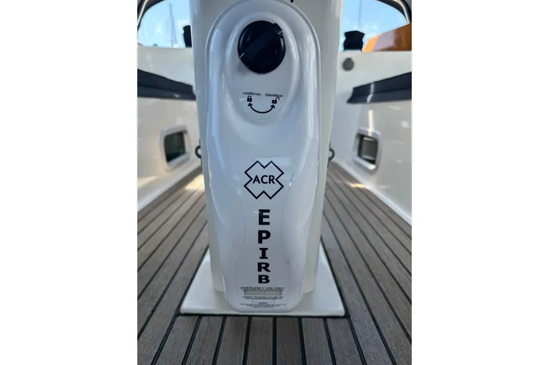 Slide: The Image of EPIRB device on 2000 Beneteau 50 yacht deck, featuring ACR branding. - 60