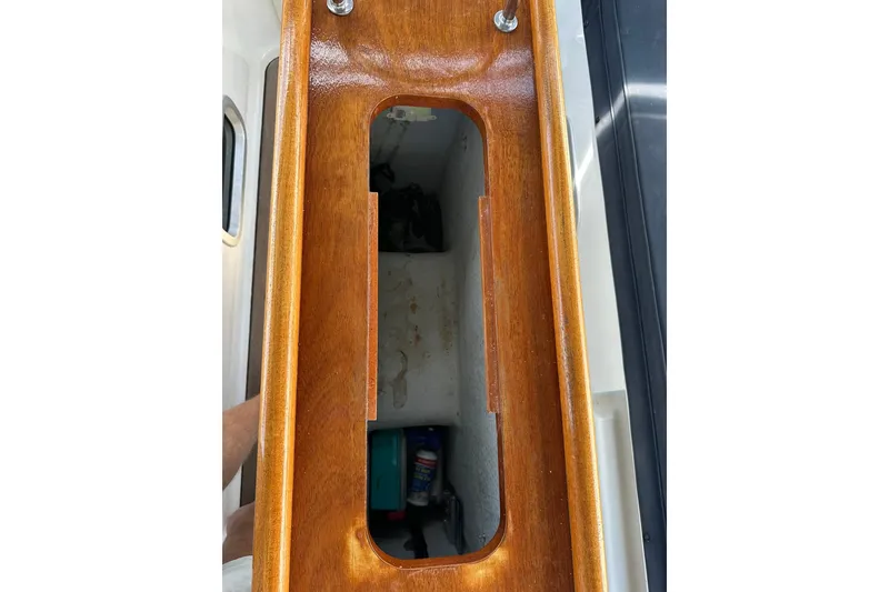 Slide: The Image of Wooden compartment on a 2000 Beneteau 50 sailboat, showcasing interior storage space. - 63