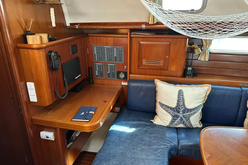 Slide: The Image of Interior of a 2000 Beneteau 50 yacht with wooden cabinetry and blue seating. - 66