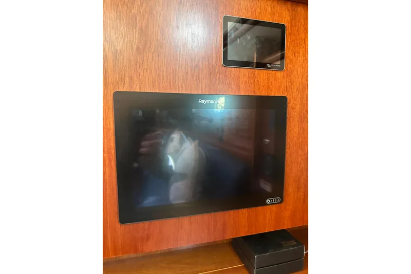 Slide: The Image of Raymarine navigation display on 2000 Beneteau 50 yacht's wooden interior panel. - 71