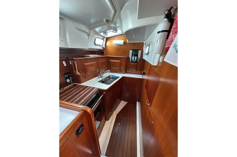Slide: The Image of Interior of 2000 Beneteau 50 yacht kitchen with wooden cabinetry and modern appliances. - 87