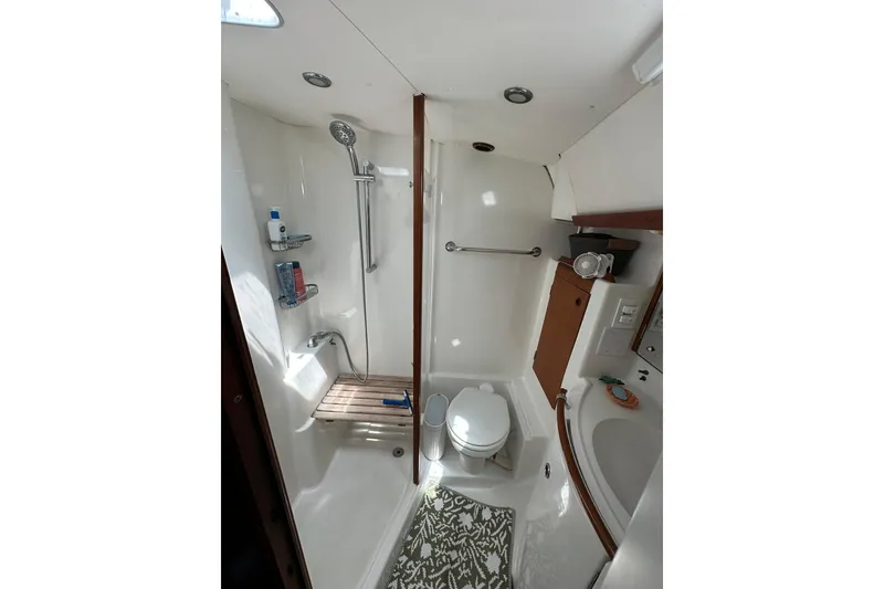 Slide: The Image of Bathroom interior of a 2000 Beneteau 50 yacht, featuring shower and toilet. - 96