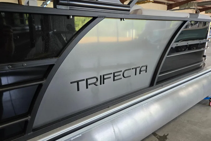 Slide: The Image of 2026 Trifecta 24RF LE 2.75 pontoon boat side view with sleek design. - 20