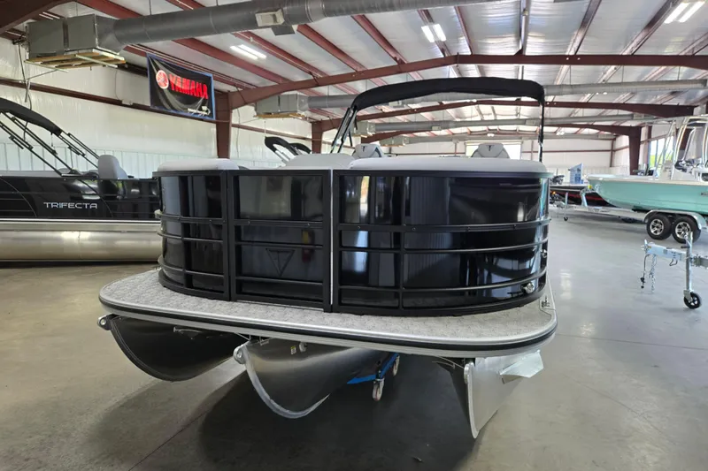Slide: The Image of 2026 Trifecta 24RF LE 2.75 pontoon boat in a showroom setting. - 22
