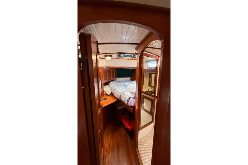 Slide: The Image of Cozy cabin interior of 1986 Westwind 38 sailboat with wooden finish and comfortable bedding. - 12