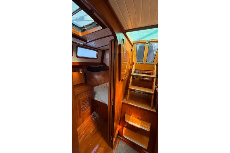 Slide: The Image of Interior of 1986 Westwind 38 sailboat, featuring wooden cabin and stairs. - 14
