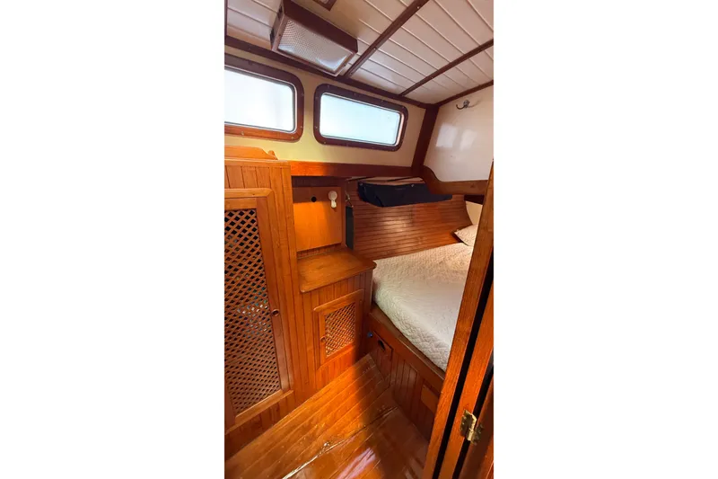 Slide: The Image of Cozy cabin interior of 1986 Westwind 38 sailboat with wooden furnishings and bed. - 17