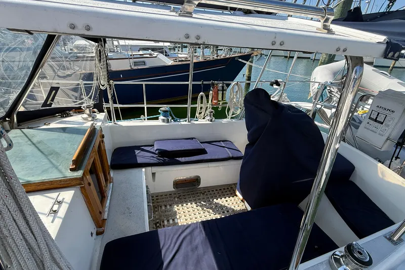 Slide: The Image of Cockpit of 1986 Westwind 38 sailboat with blue cushions and nautical equipment. - 4