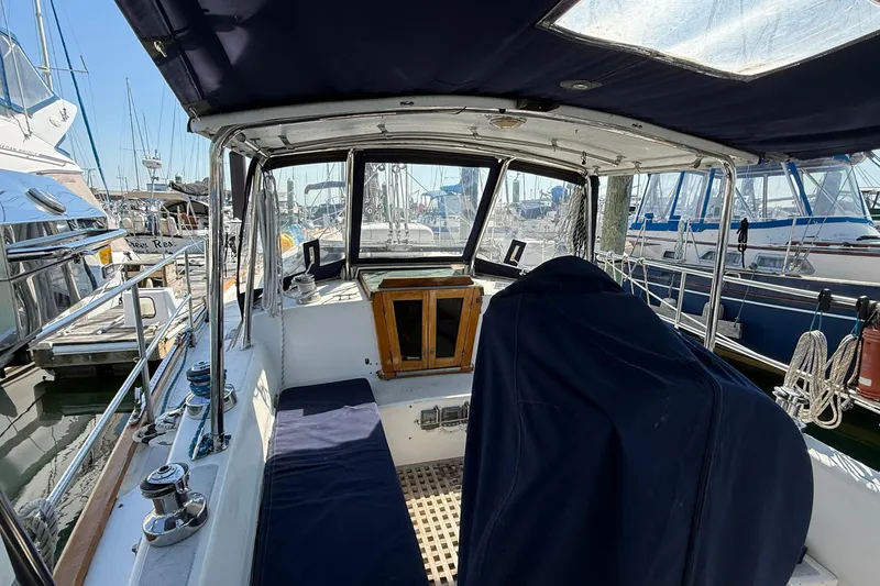 Slide: The Image of Cockpit view of a 1986 Westwind 38 sailboat docked at a marina. - 5