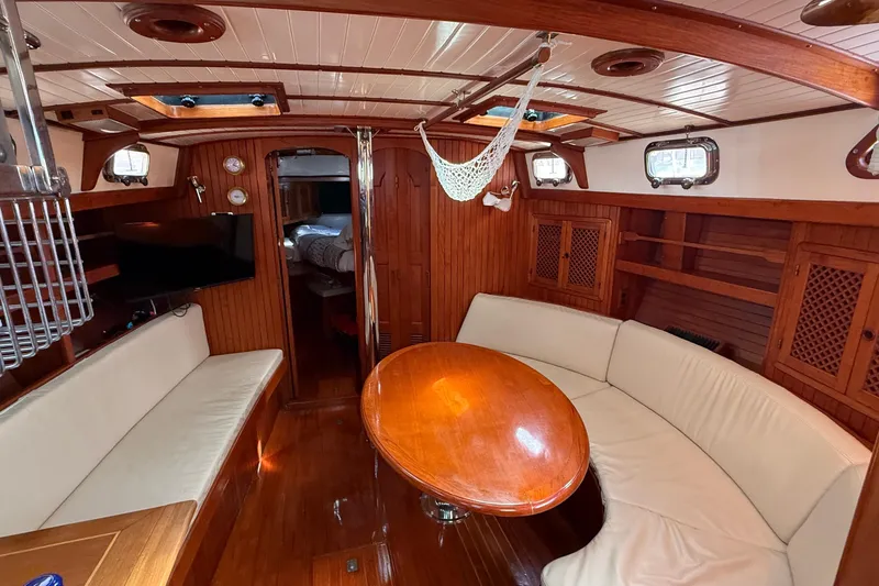 Slide: The Image of Interior of 1986 Westwind 38 sailboat with wooden finishes and cozy seating area. - 8