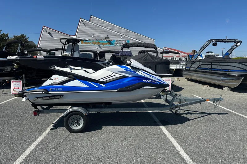 The Image of 2023 Yamaha WaveRunner FX SHO on trailer in parking lot, surrounded by boats. - 1